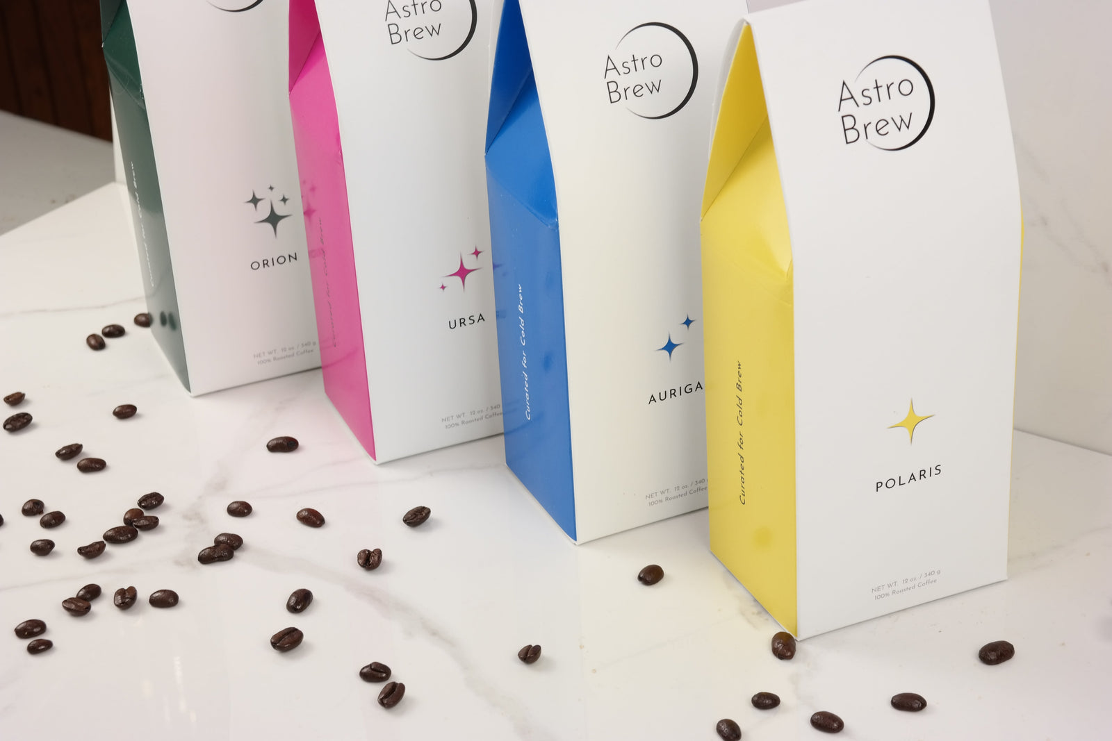 Four AstroBrew coffee bags together in a warm studio setting